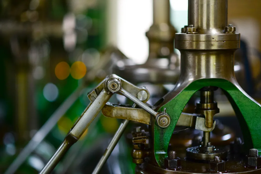 Close-up of a linkage and gland assembly on process machinery